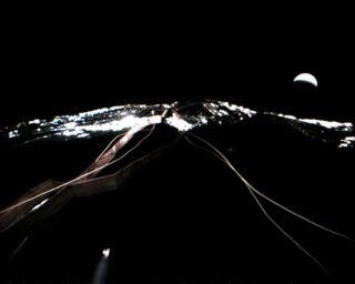 This photo shows Japan's Ikaros solar sail as it sailed by the planet Venus (which appears as the crescent at upper right) on Dec. 8, 2010. The Ikaros solar sail was about 80,000 kilometers from Venus during the flyby.