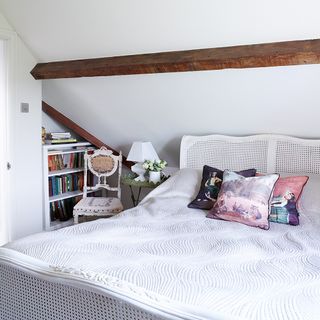 attic bedroom with bed and book shelf