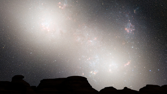 During the second close passage, the cores of the Milky Way and Andromeda appear as a pair of bright lobes. Star-forming nebulae are much less prominent because the interstellar gas and dust has been significantly decreased by previous bursts of star formation. Image released May 31, 2012.