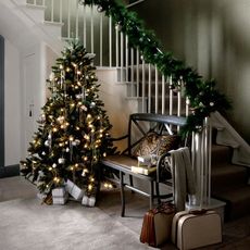 christmas decoration in hall with christmas tree lights and christmas garland at stairways