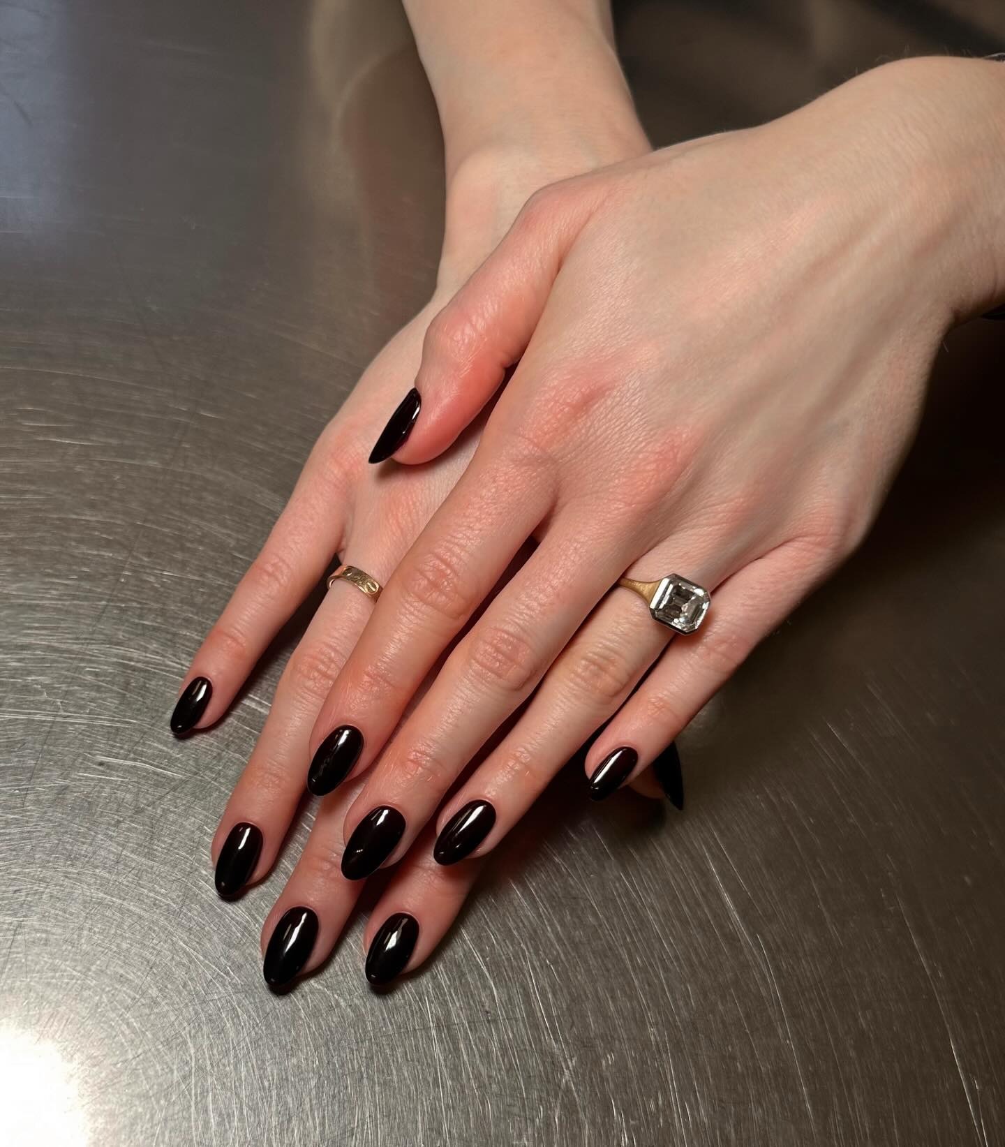 An almond-shaped glossy black manicure