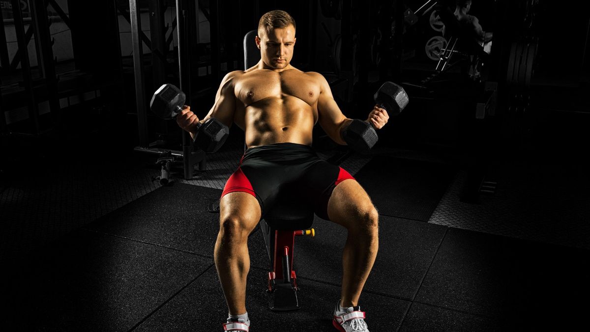 Man performs 45-degree dumbbell curl on an incline bench