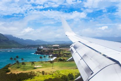 A plane flies into Lihue airport on Kauai, Hawaii
