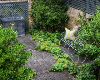 Designing a patio sympathetically to surrounding architecture, demonstrated with herringbone dark brick flooring in an industrial inspired scheme.