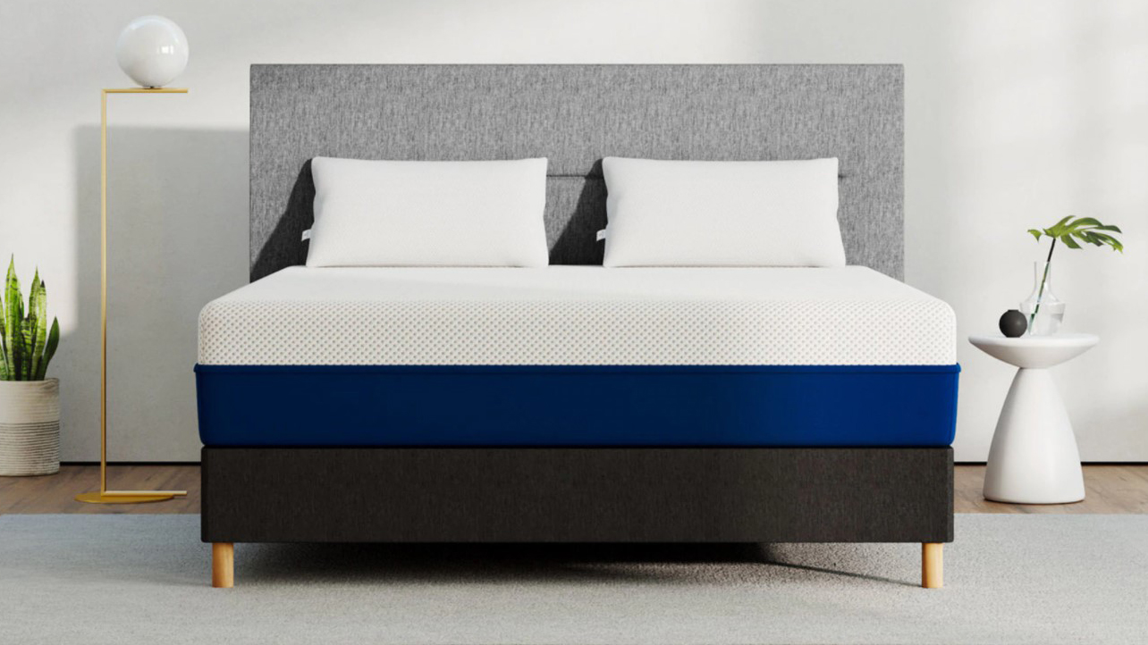 best mattress in a box: the Amerisleep AS2 shown with a blue base and placed on a light grey fabric bed base