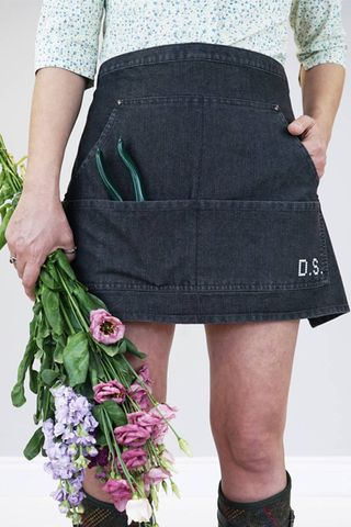 person wearing a black gardening apron