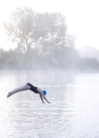 Woman diving into a lake