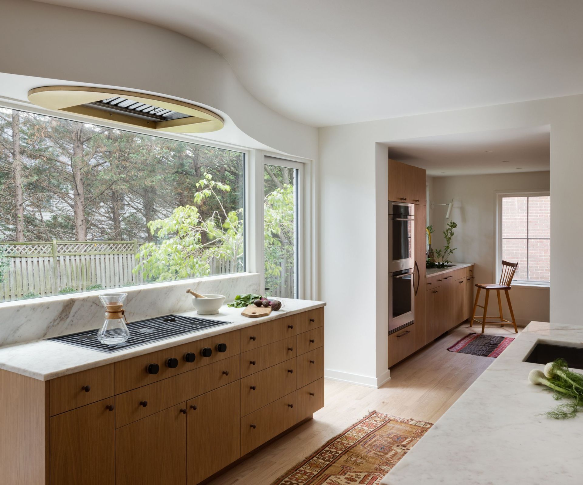 kitchen with natural wood cabinets and window over sink