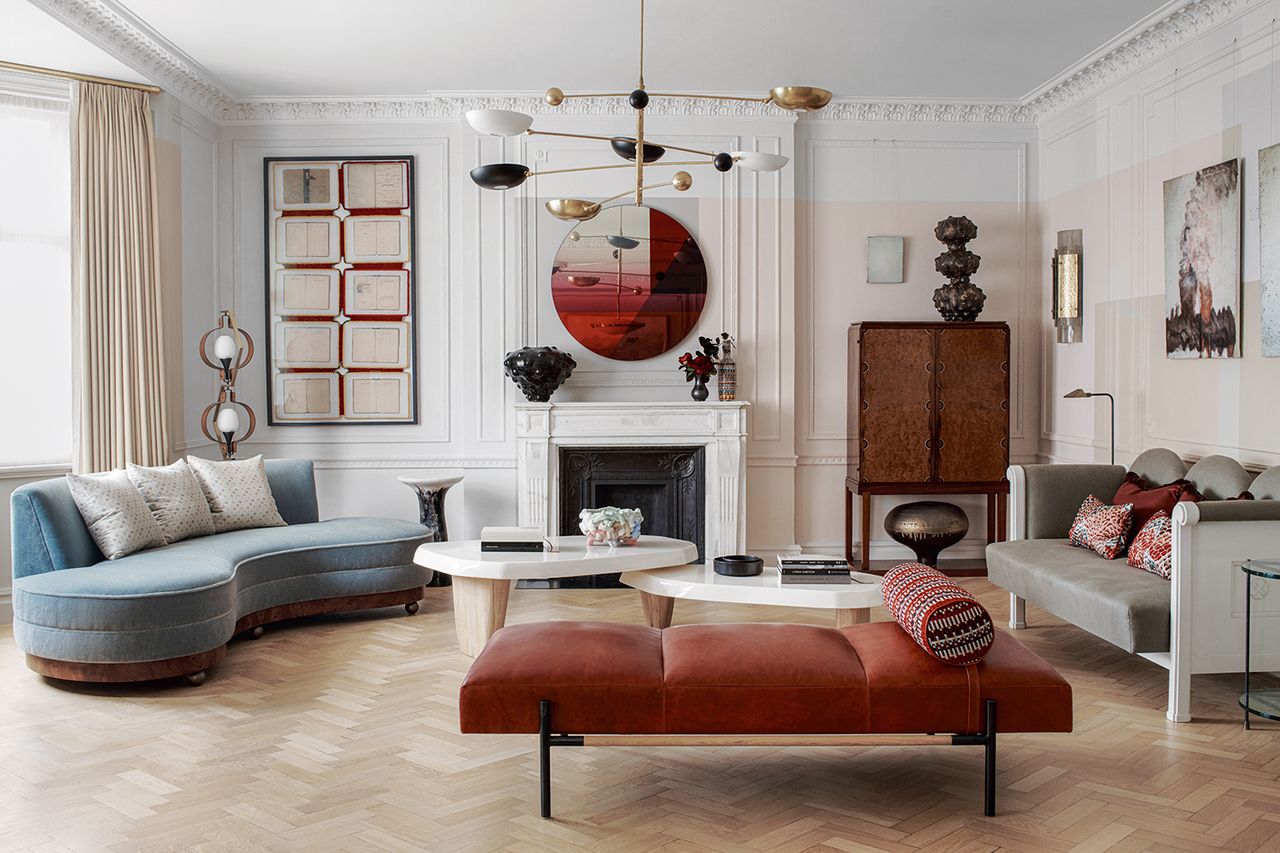 large living room with red daybed and modern blue curved sofa