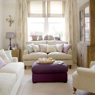 living room with white sofa set and cupboard
