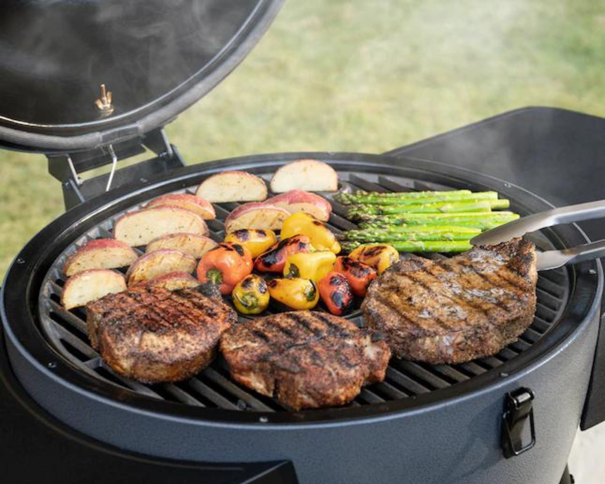 Akorn Auto-Kamado grill with food on