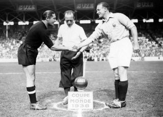 Italy's Giuseppe Meazza (left) shakes hands with French captain Etienne Mattler ahead of the teams' meeting at the 1938 World Cup.