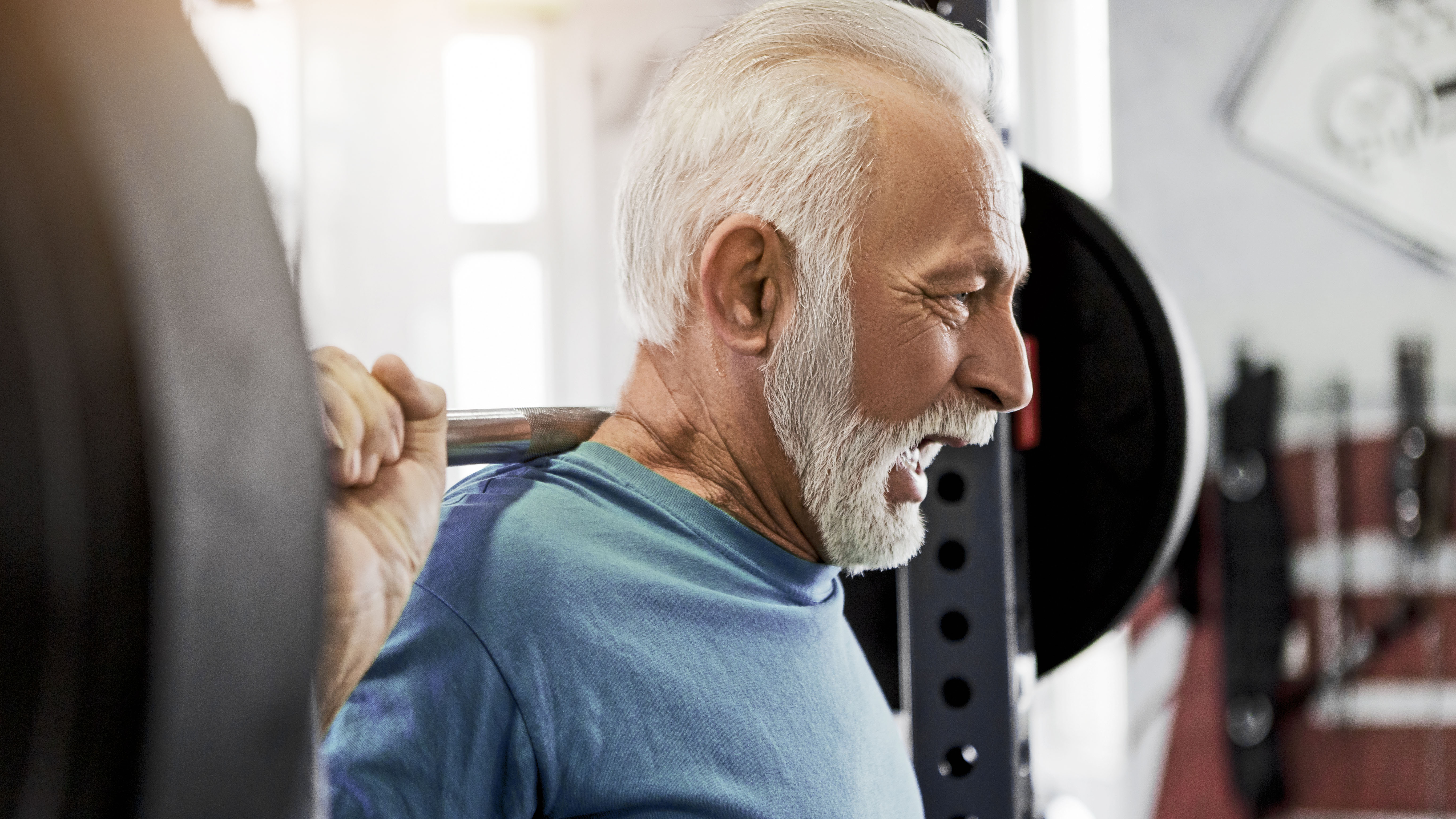 man using weight in gym