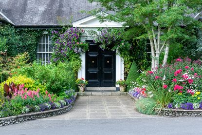 Front garden and driveway with colourful flowerbeds