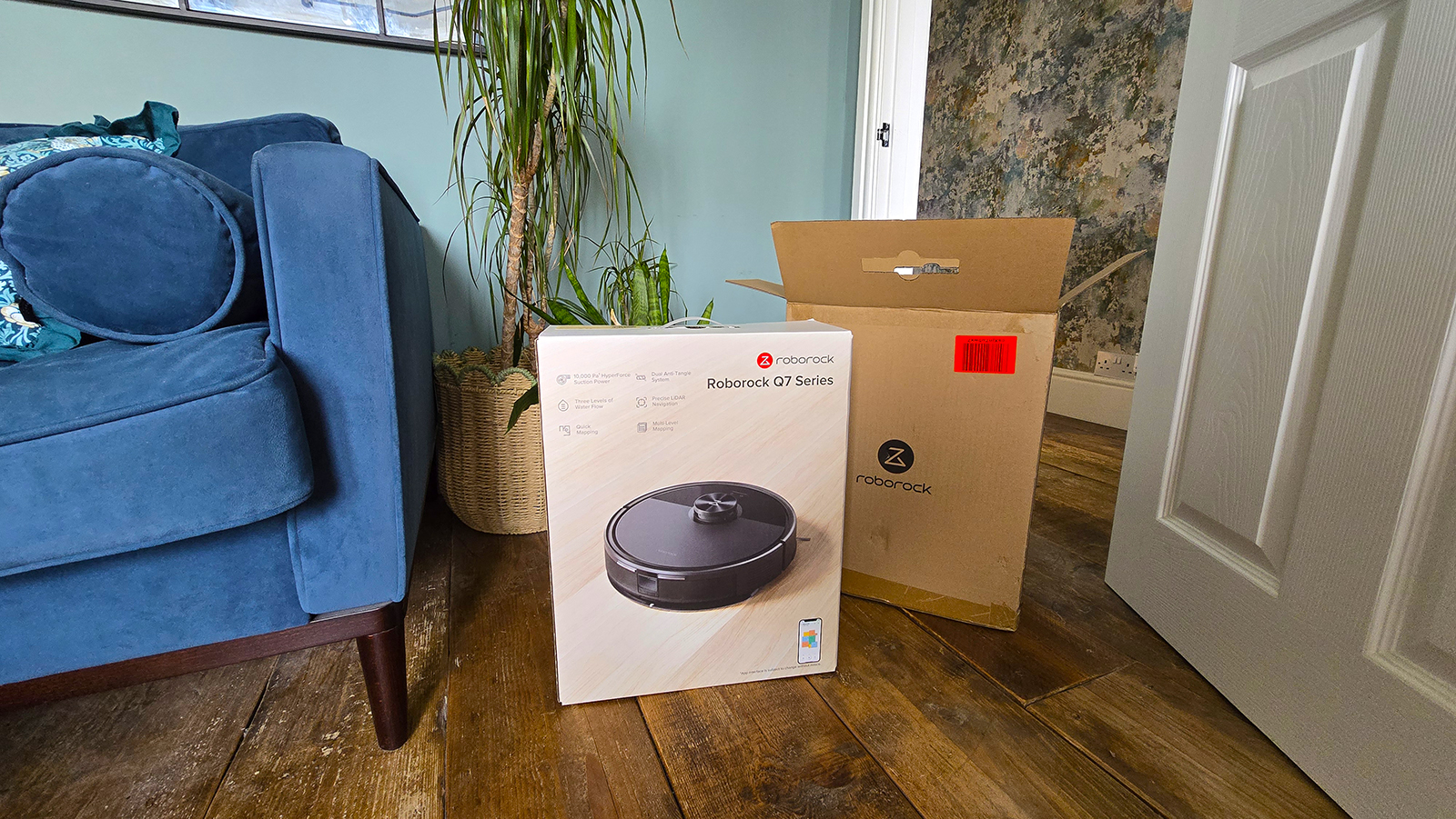 Roborock Q7 M5 on wooden floor in box