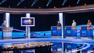 Ken Jennings, Matt Amodio, Roger Craig and Juveria Zaheer behind podiums on then Alex Trebek Stage on Jeopardy! Masters