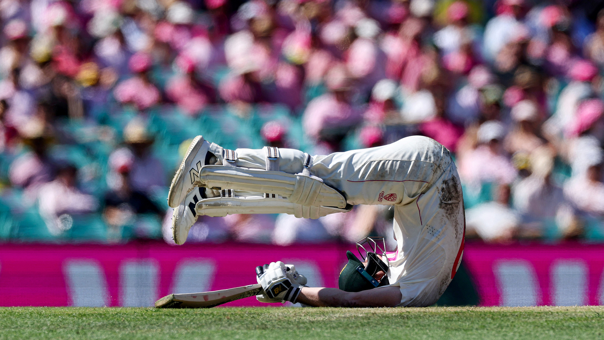 Cricketer Steve Smith tumbles onto the field during the fifth Ashes Test between Australia and England at the SCG in Sydney