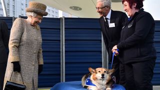 Queen Elizabeth greeting Paul O'Grady and a corgi