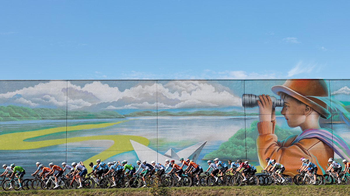 Picture by Alex Whitehead/SWpix.com - 06/10/2024 - Cycling - 2024 UCI Gravel World Championships, Halle-Leuven, Belgium - Men Elite Race - The Bunch passes a Mural âThe Enchanted Forestâ