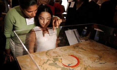 Spectators look closely at a scale model of the Flight 93 National Memorial, which some claim is full of Islamic symbolism. 