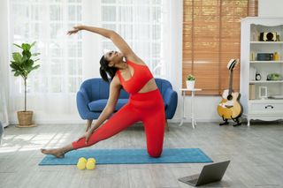 woman doing yoga video in home.