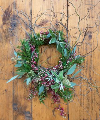 Willow and peppercorn wreath on wooden background