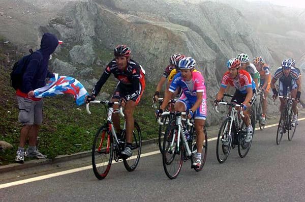The yellow jersey group gets a cheer from a lone spectator