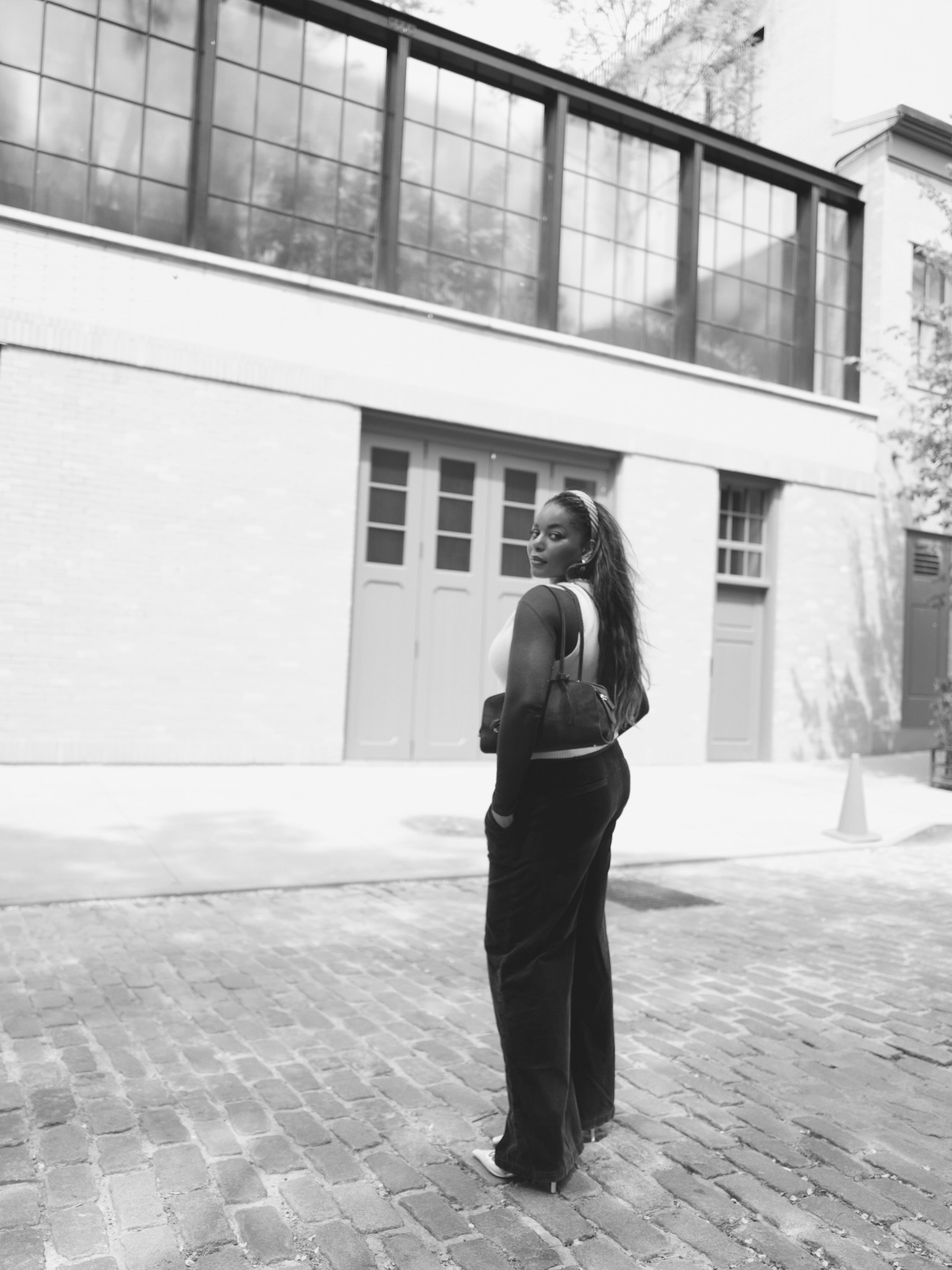 Kaye Bassey wearing a headband, white tank, and trousers.