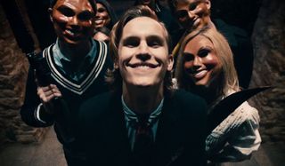 Rhys Wakefield smiles menacingly with his fellow Purgers in The Purge.