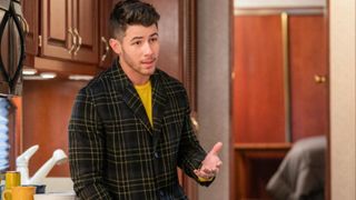 Nick Jonas offers some sage advice in front of a kitchen cabinet