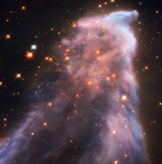 This ghostly nebula IC 63, about 550 light-years from Earth, emits hydrogen-alpha radiation and also reflects the cool blue light of the powerful nearby star Gamma Cassiopeiae. The nebula is about 0.31 light-years tall and 0.23 light-years wide.