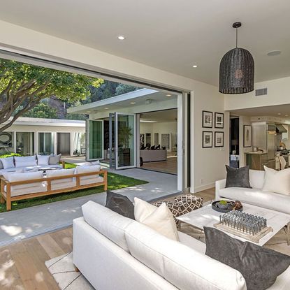 living room with wooden flooring and sofaset with cushions