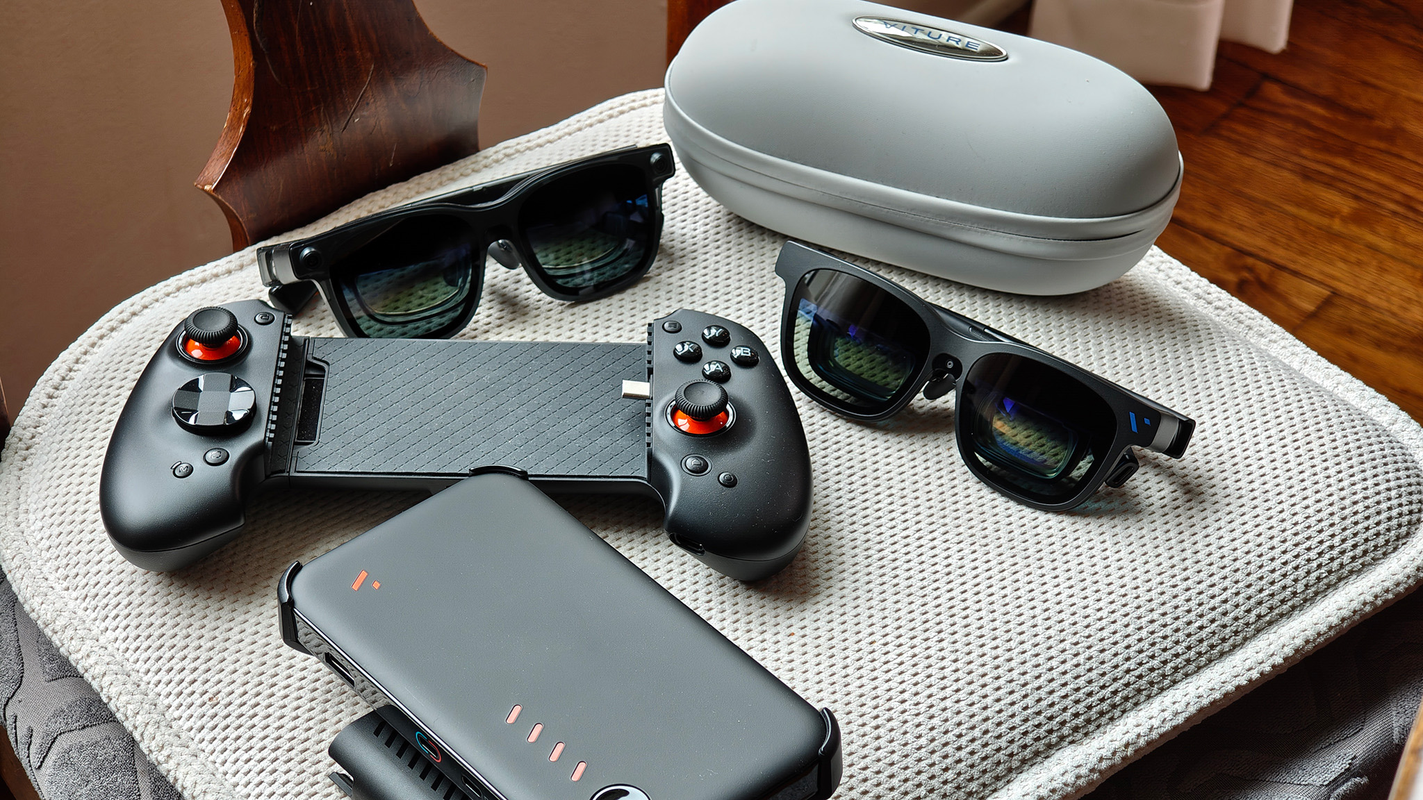 A Viture Pro Mobile dock, Viture Beast, Viture Luma Pro, and Abxylute S9V controller on a chair