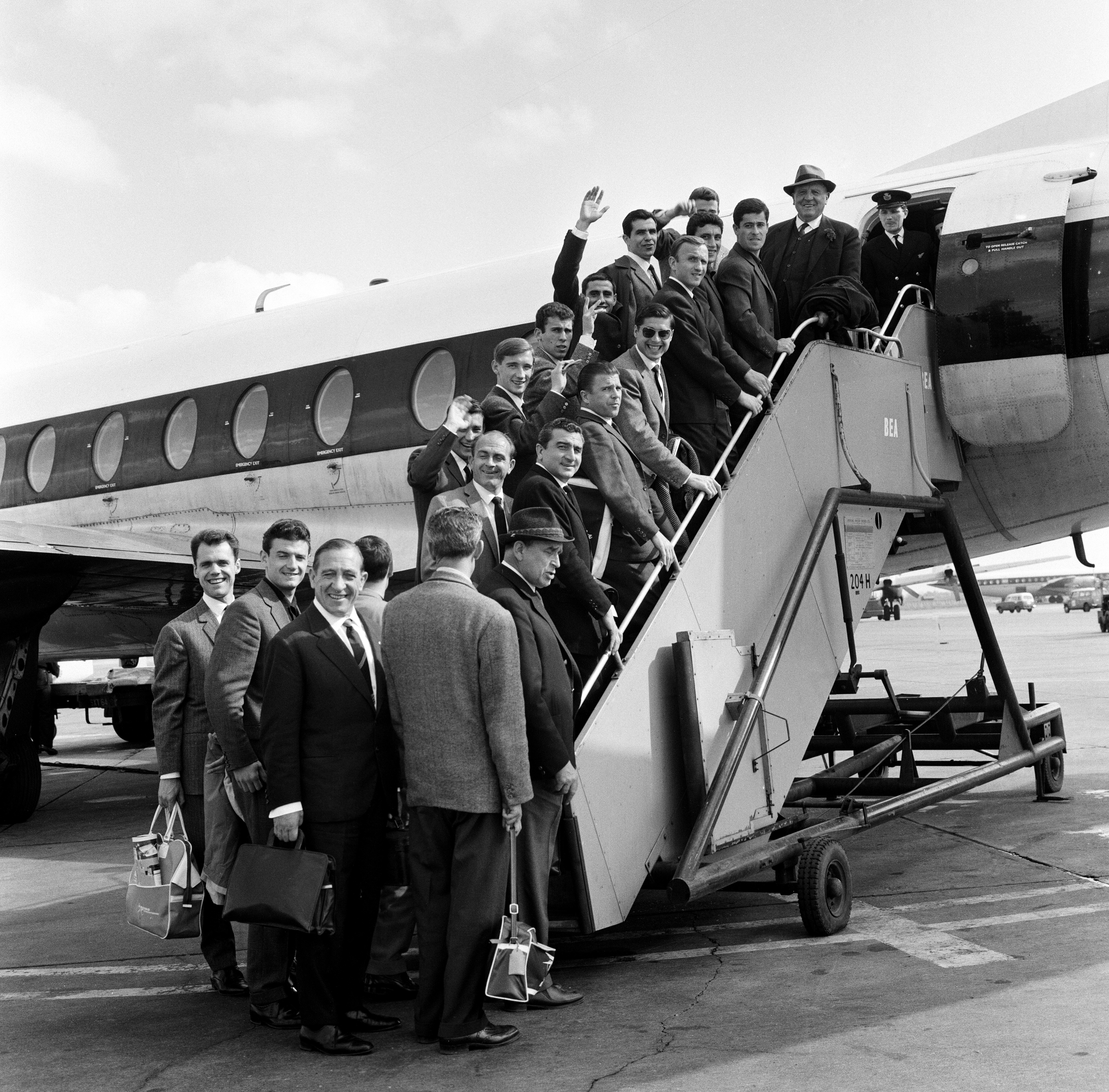 Real Madrid football team waving goodbye as they board a plane