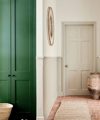 Little Greene Portland Stone used in a kitchen with a green accent wall