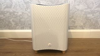 Mila Air Purifier review: the unit sat against a wall covered in white and grey Japanese print wallpaper