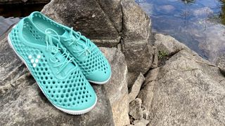 Vivobarefoot Ultra Bloom III water shoes on a rock