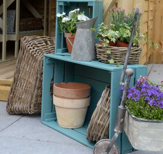 blue painted crates for storage in garden