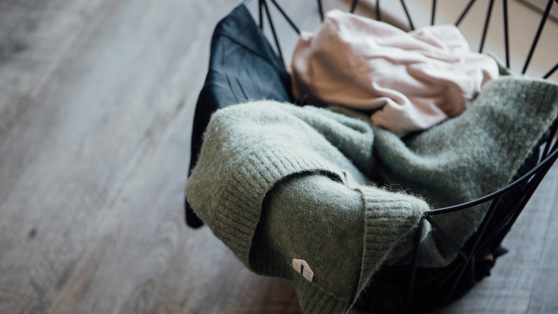 clothes inside and coming out of a clothes/laundry hamper