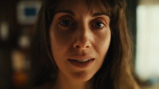 Alison Brie looking at camera in Together.
