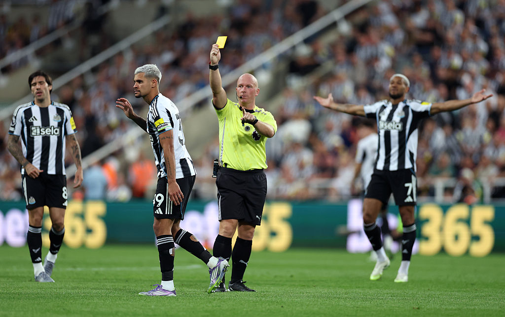 Bruno Guimaraes receives a yellow card