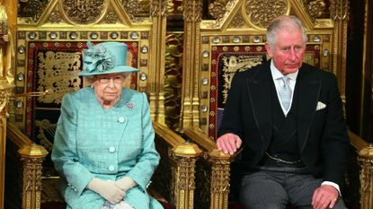 Queen Elizabeth II and her son Prince Charles, Prince of Wales sit in the House of Lords chamber during the State Opening of Parliament