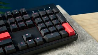 A black Lemokey X3 wired gaming keyboard with red keycaps