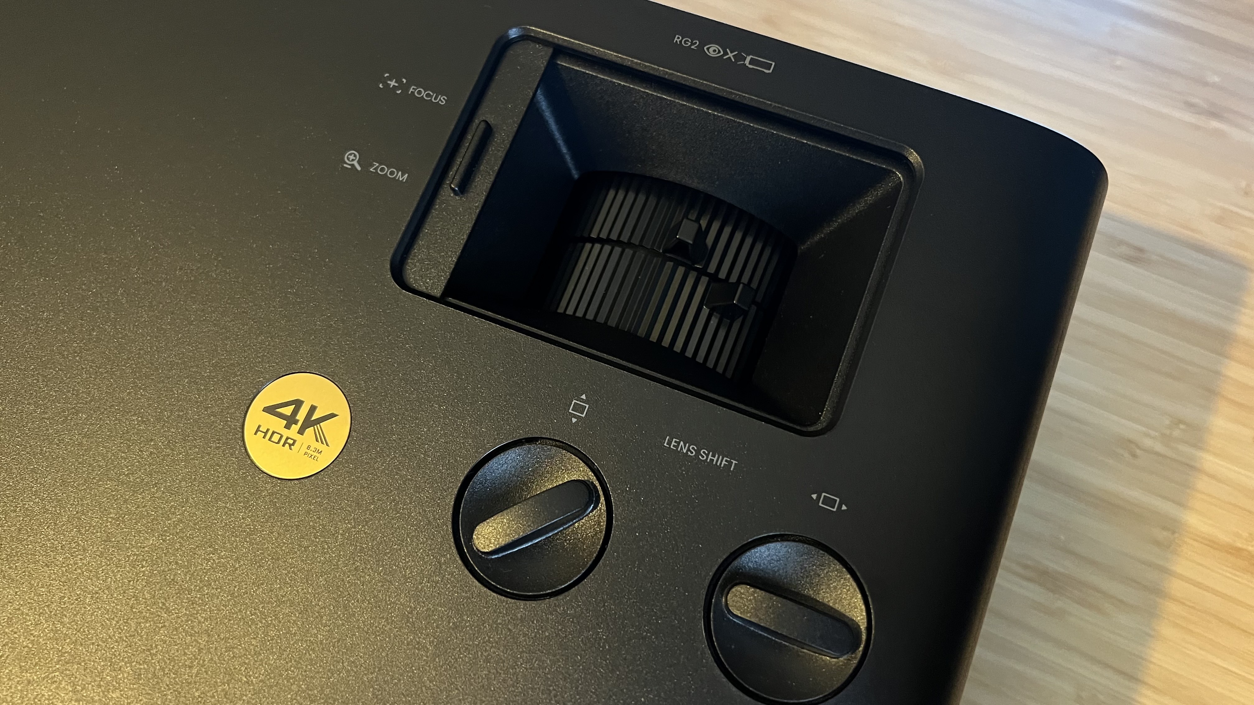 Close up on lens shift, zoom, and focus controls on BenQ W4100i projector