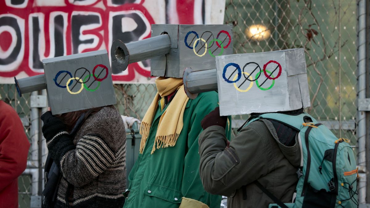 Protesters take part in a demonstration against the Paris 2024 Olympic and Paralympic Games, in front of the organizing committee&#039;s headquarters in Saint-Denis, outside Paris, on December 11, 2022., to denounce, among others, the alleged increase in surveillance cameras to be established around neighborhoods hosting Olympic venues.