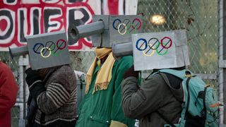 Protesters take part in a demonstration against the Paris 2024 Olympic and Paralympic Games, in front of the organizing committee's headquarters in Saint-Denis, outside Paris, on December 11, 2022., to denounce, among others, the alleged increase in surveillance cameras to be established around neighborhoods hosting Olympic venues.