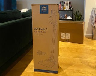 VAX Blade 5 Dual Pet & Car Cordless Vacuum Cleaner in box on laminate flooring