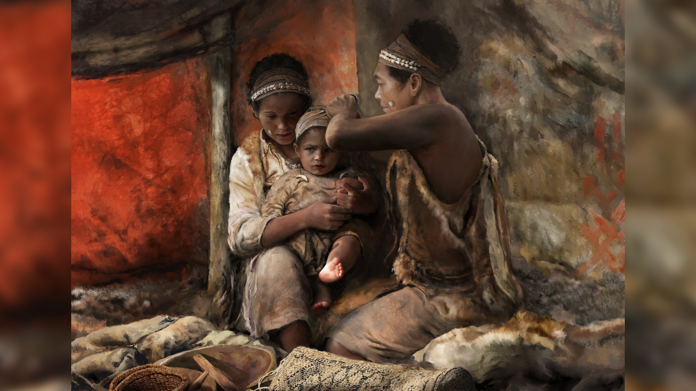 two brown-skinned people in a cave wrap a baby&#039;s head with a piece of fabric