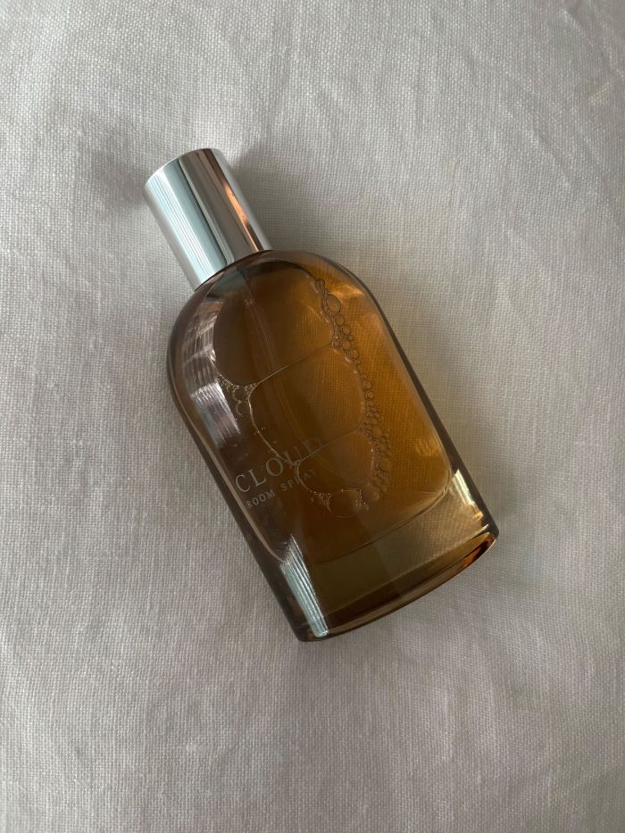 An M&amp;amp;S room spray on a white linen background