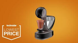 The Nescafé Dolce Gusto Infinissima pod coffee machine on a orange background
